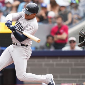 Jun 30, 2024; Toronto, Ontario, CAN; New York Yankees right fielder Juan Soto (22) hits a single against the Toronto Blue Jays during the first inning at Rogers Centre. 