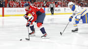 Mar 30, 2025; Washington, District of Columbia, USA; Washington Capitals center Aliaksei Protas (21) skates with the puck past Buffalo Sabres defenseman Owen Power (25) to score a goal during the third period at Capital One Arena. Mandatory Credit: Amber Searls-Imagn Images