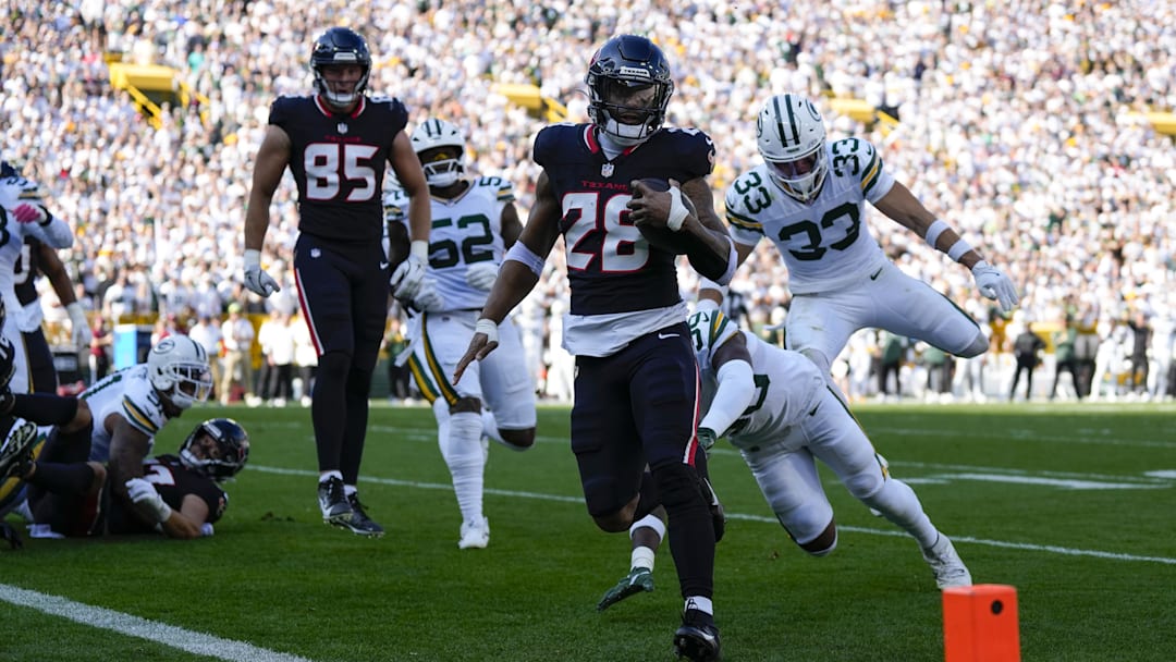 Oct 20, 2024; Green Bay, Wisconsin, USA;  Houston Texans running back Joe Mixon (28) rushes for a touchdown during the second quarter against the Green Bay Packers at Lambeau Field. Mandatory Credit: Jeff Hanisch-Imagn Images