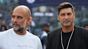 Jul 27, 2024; New York, NY, USA; AC Milan head coach Paulo Fonseca and Manchester City head coach Pep Guardiola talk before the match at Yankee Stadium. Mandatory Credit: Lucas Boland-Imagn Images