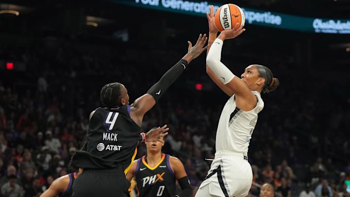 Aug 15, 2025; Phoenix, Arizona, USA; Las Vegas Aces center A'ja Wilson (22) shoots over Phoenix Mercury forward Natasha Mack (4) in the first half at Footprint Center. Mandatory Credit: Rick Scuteri-Imagn Images Aug 15, 2025; Phoenix, Arizona, USA; Las Vegas Aces center A'ja Wilson (22) shoots over Phoenix Mercury forward Natasha Mack (4) in the first half at Footprint Center. Mandatory Credit: Rick Scuteri-Imagn Images