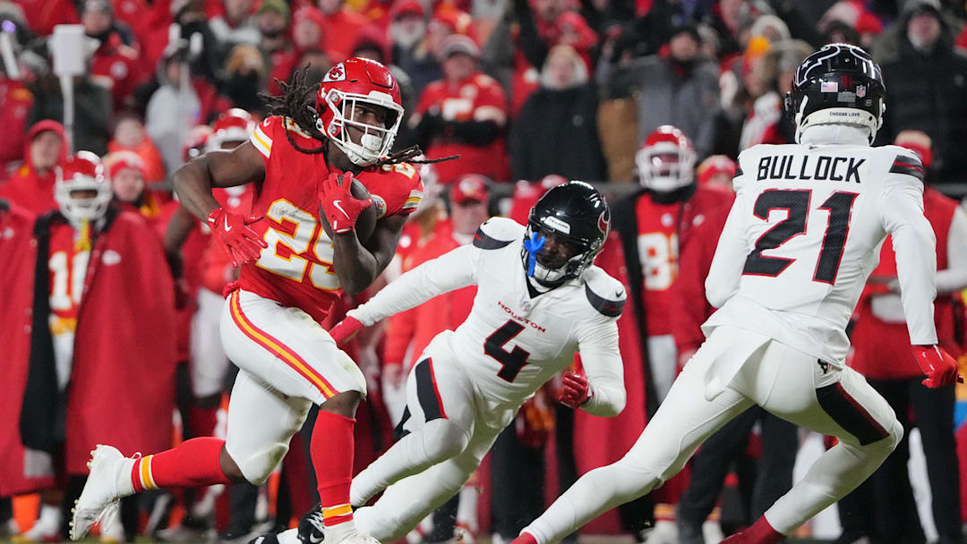 Jan 18, 2025; Kansas City, Missouri, USA; Kansas City Chiefs running back Kareem Hunt (29) runs the ball against Houston Texans cornerback Kamari Lassiter (4) and safety Calen Bullock (21) during the fourth quarter of a 2025 AFC divisional round game at GEHA Field at Arrowhead Stadium. Mandatory Credit: Denny Medley-Imagn Images