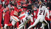 Jan 18, 2025; Kansas City, Missouri, USA; Kansas City Chiefs running back Kareem Hunt (29) runs the ball against Houston Texans cornerback Kamari Lassiter (4) and safety Calen Bullock (21) during the fourth quarter of a 2025 AFC divisional round game at GEHA Field at Arrowhead Stadium. Mandatory Credit: Denny Medley-Imagn Images