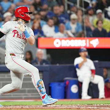 Sep 3, 2024; Toronto, Ontario, CAN; Philadelphia Phillies first base Bryce Harper (3) hits a single against the Toronto Blue Jays during the eighth inning at Rogers Centre. 