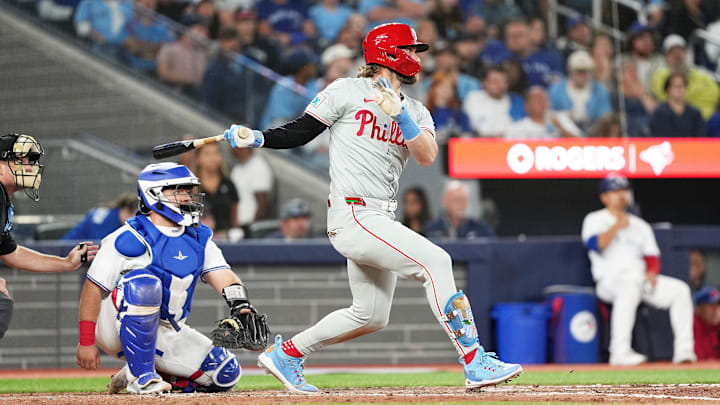 Sep 3, 2024; Toronto, Ontario, CAN; Philadelphia Phillies first base Bryce Harper (3) hits a single against the Toronto Blue Jays during the eighth inning at Rogers Centre. 