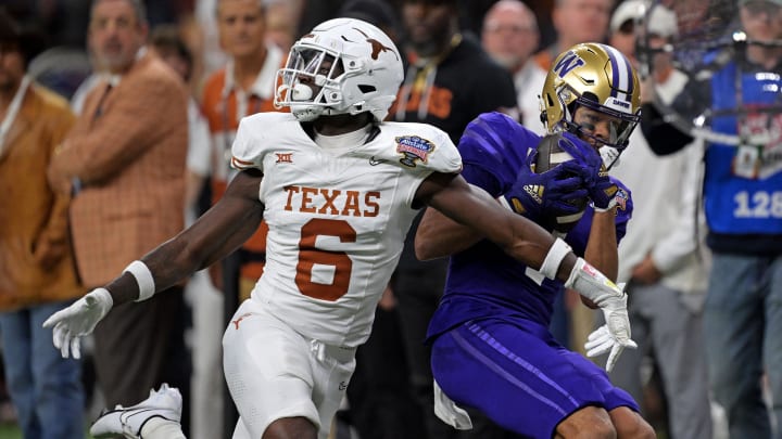 Jan 1, 2024; New Orleans, LA, USA; Washington Huskies wide receiver Rome Odunze (1) catches a pass against Texas Longhorns defensive back Ryan Watts (6) during the fourth quarter in the 2024 Sugar Bowl college football playoff semifinal game at Caesars Superdome. Mandatory Credit: Matthew Hinton-USA TODAY Sports