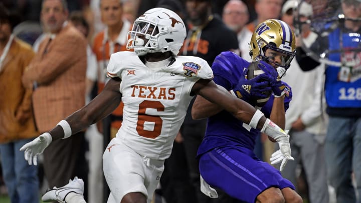 Jan 1, 2024; New Orleans, LA, USA; Washington Huskies wide receiver Rome Odunze (1) catches a pass against Texas Longhorns defensive back Ryan Watts (6) during the fourth quarter in the 2024 Sugar Bowl college football playoff semifinal game at Caesars Superdome. Mandatory Credit: Matthew Hinton-USA TODAY Sports