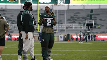 Nov 15, 2025; East Lansing, Michigan, USA; Michigan State quarterback Aidan Chiles (2) chats with Michigan State offensive lineman Kristian Phillips (71) during warmups before a game against the Penn State Nittany Lions at Spartan Stadium. Mandatory Credit: Brendan Mullin-Imagn Images