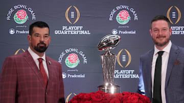 Dec 31, 2024; Los Angeles, California, USA; Ohio State Buckeyes head coach Ryan Day (left) and Oregon Ducks head coach Dan Lanning pose with the Leishman Trophy during the Rose Bowl head coaches press conference at Sheraton Grand LA. Mandatory Credit: Kirby Lee-Imagn Images