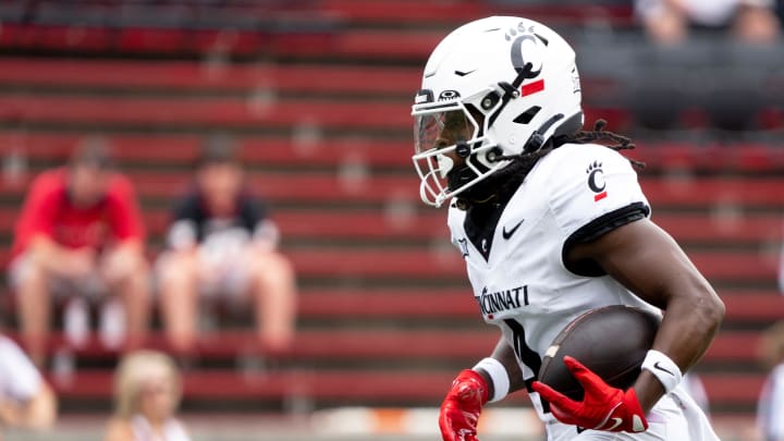 Cincinnati Bearcats wide receiver Tyrin Smith (4) runs the ball before the College Football game between the Cincinnati Bearcats and the Towson Tigers at Nippert Stadium in Cincinnati on Saturday, Aug. 31, 2024.