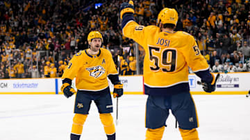 Jan 21, 2025; Nashville, Tennessee, USA;  Nashville Predators left wing Filip Forsberg (9) cebrates the goal of defenseman Roman Josi (59) against the San Jose Sharks during the third period at Bridgestone Arena. Mandatory Credit: Steve Roberts-Imagn Images