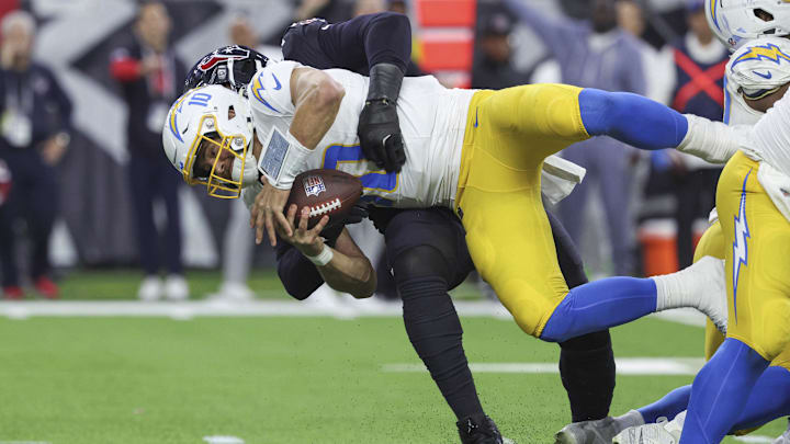 Jan 11, 2025; Houston, Texas, USA; Houston Texans defensive end Denico Autry (96) sacks Los Angeles Chargers quarterback Justin Herbert (10) during the game in an AFC wild card game at NRG Stadium. Mandatory Credit: Troy Taormina-Imagn Images Jan 11, 2025; Houston, Texas, USA; Houston Texans defensive end Denico Autry (96) sacks Los Angeles Chargers quarterback Justin Herbert (10) during the game in an AFC wild card game at NRG Stadium. Mandatory Credit: Troy Taormina-Imagn Images