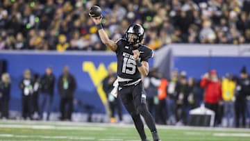 Oct 25, 2025; Morgantown, West Virginia, USA; West Virginia Mountaineers quarterback Scotty Fox Jr. (15) throws a pass during the first quarter against the Texas Christian University Horned Frogs at Milan Puskar Stadium. Mandatory Credit: Ben Queen-Imagn Images