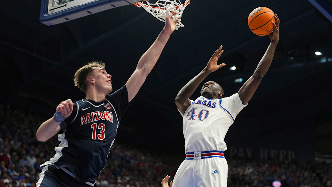 Feb 9, 2026; Lawrence, Kansas, USA; Kansas Jayhawks forward Flory Bidunga (40) shoots against Arizona Wildcats center Motiejus Krivas (13) during the second half at Allen Fieldhouse. Mandatory Credit: Jay Biggerstaff-Imagn Images