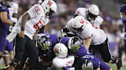 Oct 4, 2024; Fort Worth, Texas, USA; Houston Cougars quarterback Zeon Chriss (2) is gang tackled by the TCU Horned Frogs defense in the third quarter at Amon G. Carter Stadium. Mandatory Credit: Tim Heitman-Imagn Images