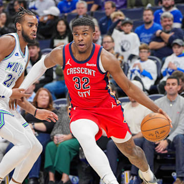 Nov 8, 2023; Minneapolis, Minnesota, USA; New Orleans Pelicans forward E.J. Liddell (32) dribbles against the Minnesota Timberwolves forward Troy Brown Jr. (23) in the fourth quarter at Target Center.