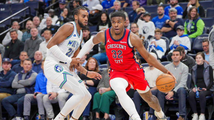 Nov 8, 2023; Minneapolis, Minnesota, USA; New Orleans Pelicans forward E.J. Liddell (32) dribbles against the Minnesota Timberwolves forward Troy Brown Jr. (23) in the fourth quarter at Target Center. 