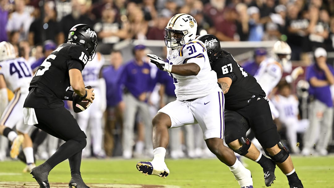 Oct 26, 2024; College Station, Texas, USA; LSU Tigers defensive tackle Jay'viar Suggs (31) applies pressure to Texas A&M Aggies quarterback Conner Weigman (15) during the third quarter. The Aggies defeated the Tigers 38-23; at Kyle Field. Mandatory Credit: Maria Lysaker-Imagn Images.