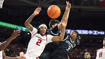 Nov 22, 2024; Fayetteville, Arkansas, USA; Arkansas Razorbacks guard Boogie Fland (2) and Little Rock Trojans guard Isaiah Lewis (3) reach for a rebound in the first half at Bud Walton Arena. Mandatory Credit: Nelson Chenault-Imagn Images