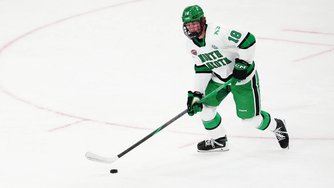 Apr 9, 2026; Las Vegas, Nevada, UNITED STATES;  North Dakota Fighting Hawks defenseman Keaton Verhoeff (18) moves the puck in the first period against the Wisconsin Badgers  in the semifinals of the NCAA men's ice hockey Frozen Four at T-Mobile Arena. Mandatory Credit: Stephen R. Sylvanie-Imagn Images