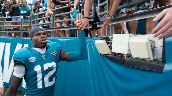 Jacksonville Jaguars wide receiver Travis Hunter (12) gives high-fives and signed autographs after the game between the Carolina Panthers at Jacksonville Jaguars at EverBank Stadium Sunday September 7, 2025. Jaguars defeated the Panthers 26-10. [Doug Engle/Florida Times-Union]