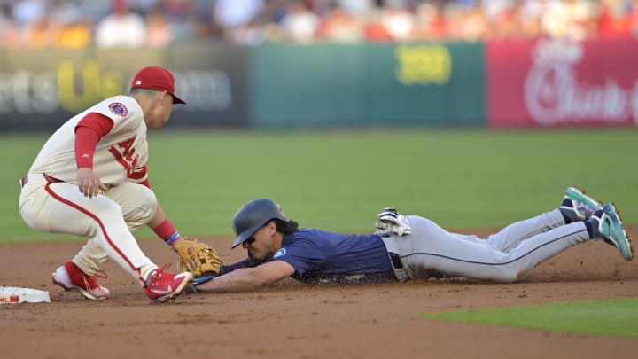 Jul 13, 2024; Anaheim, California, USA;  Josh Rojas #4 of the Seattle Mariners is caught stealing on tag by Keston Hiura #13 of the Los Angeles Angels in the second inning at Angel Stadium. Mandatory Credit: Jayne Kamin-Oncea-USA TODAY Sports