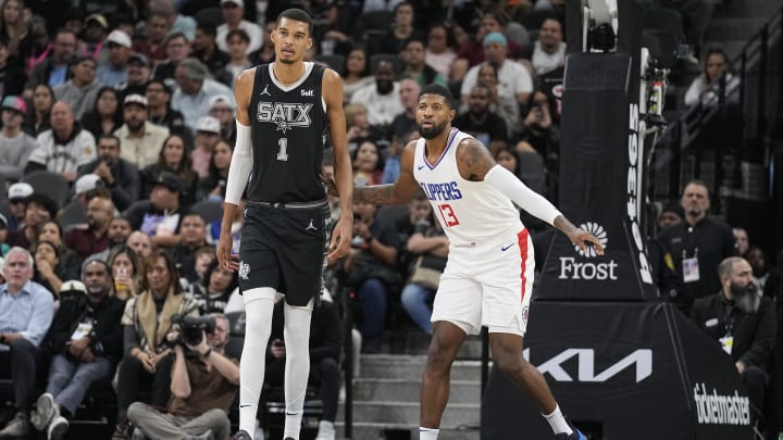 Nov 22, 2023; San Antonio, Texas, USA; Los Angeles Clippers forward Paul George (13) defends San Antonio Spurs forward Victor Wembanyama (1) during the first half at Frost Bank Center.
