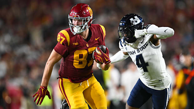 USC Trojans tight end Lake McRee (87) runs the ball against Utah State Aggies cornerback D.J. Graham II (4)