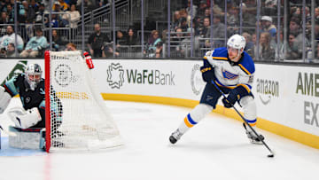 Apr 12, 2025; Seattle, Washington, USA; St. Louis Blues center Radek Faksa (12) plays the puck during the third period against the Seattle Kraken at Climate Pledge Arena. Mandatory Credit: Steven Bisig-Imagn Images