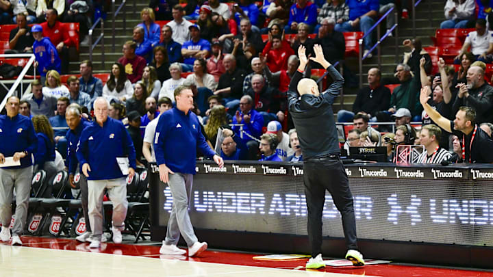 Feb 15, 2025; Salt Lake City, Utah, USA; Utah Utes head coach Craig Smith thanks fans on his way to shake Kansas Jayhawks head coach Bill Self’s hand following the game at the Jon M. Huntsman Center. Mandatory Credit: Christopher Creveling-Imagn Images