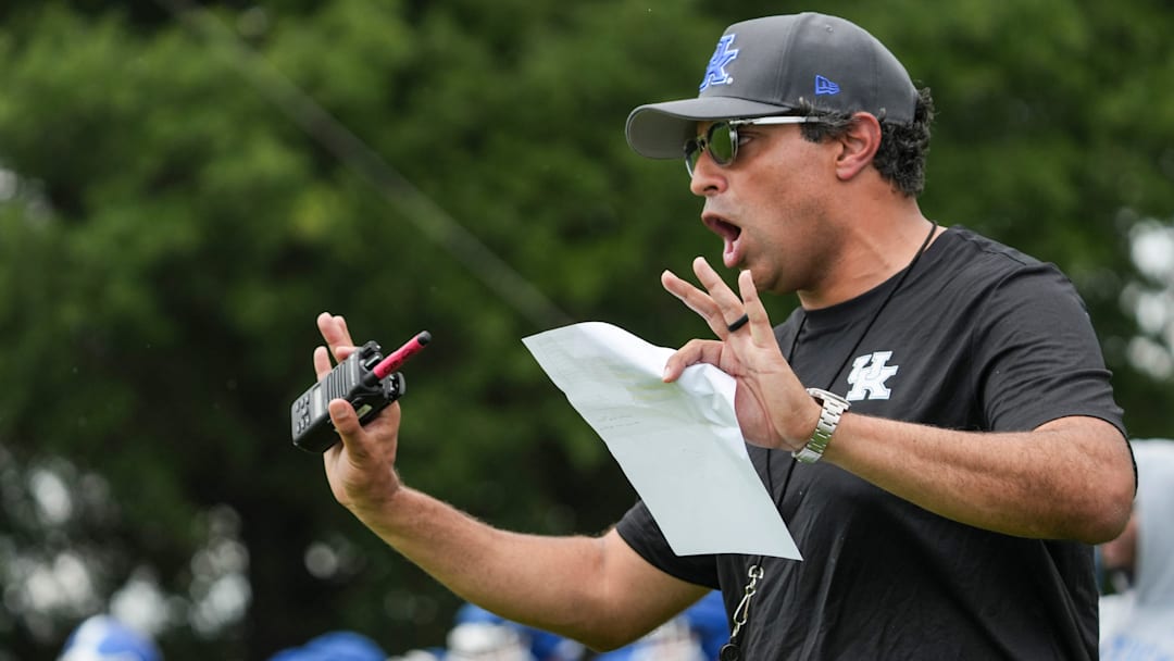 New Kentucky offensive coordinator Bush Hamdan coaches during practice Friday. August 2, 2024 in Lexington. Hamdan came from Boise State; he's also coached at Missouri, the Atlanta Falcons and Florida as well. New Kentucky offensive coordinator Bush Hamdan coaches during practice Friday. August 2, 2024 in Lexington. Hamdan came from Boise State; he's also coached at Missouri, the Atlanta Falcons and Florida as well.