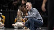 Mar 7, 2025; Kansas City, MO, USA; West Virginia Mountaineers head coach Mark Kellogg looks on from the sideline in the first quarter against the Kansas State Wildcats at T-Mobile Center. Mandatory Credit: Amy Kontras-Imagn Images