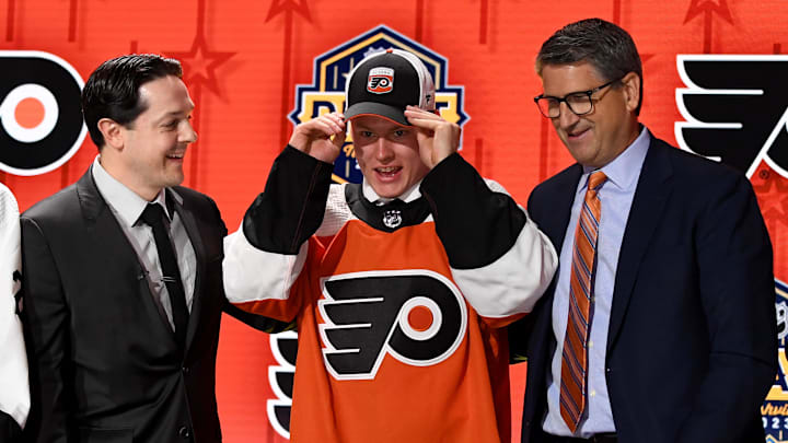 Jun 28, 2023; Nashville, Tennessee, USA; Philadelphia Flyers draft pick Matvei Michkov puts on his hat after being selected with the seventh pick in round one of the 2023 NHL Draft at Bridgestone Arena. Mandatory Credit: Christopher Hanewinckel-Imagn Images