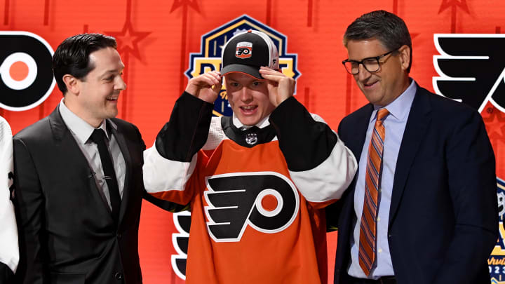 Jun 28, 2023; Nashville, Tennessee, USA; Philadelphia Flyers draft pick Matvei Michkov puts on his hat after being selected with the seventh pick in round one of the 2023 NHL Draft at Bridgestone Arena. Mandatory Credit: Christopher Hanewinckel-USA TODAY Sports