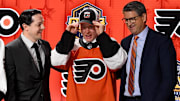 Jun 28, 2023; Nashville, Tennessee, USA; Philadelphia Flyers draft pick Matvei Michkov puts on his hat after being selected with the seventh pick in round one of the 2023 NHL Draft at Bridgestone Arena. Mandatory Credit: Christopher Hanewinckel-Imagn Images