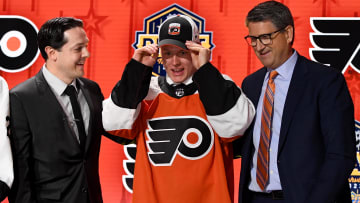 Jun 28, 2023; Nashville, Tennessee, USA; Philadelphia Flyers draft pick Matvei Michkov puts on his hat after being selected with the seventh pick in round one of the 2023 NHL Draft at Bridgestone Arena. Mandatory Credit: Christopher Hanewinckel-USA TODAY Sports