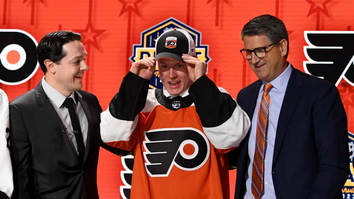 Jun 28, 2023; Nashville, Tennessee, USA; Philadelphia Flyers draft pick Matvei Michkov puts on his hat after being selected with the seventh pick in round one of the 2023 NHL Draft at Bridgestone Arena. Mandatory Credit: Christopher Hanewinckel-USA TODAY Sports