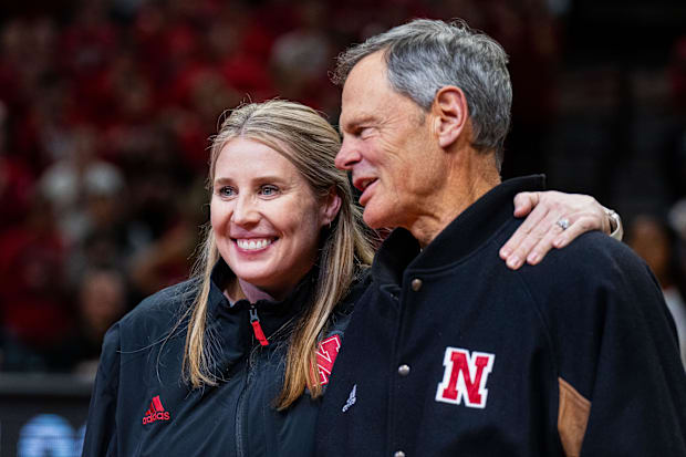 Nebraska Cornhuskers volleyball head coach Dani Busboom Kelly and former coach John Cook embrace while being recognized.