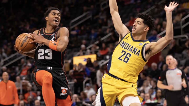 Mar 20, 2024; Detroit, Michigan, USA; Detroit Pistons guard Jaden Ivey (23) drives to the basket next to Indiana Pacers guard Ben Sheppard (26) in the first half at Little Caesars Arena. Mandatory Credit: David Reginek-USA TODAY Sports