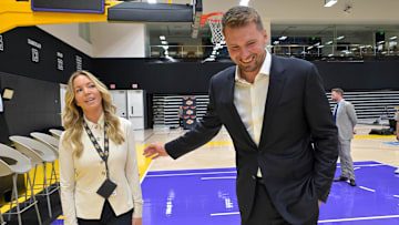 Los Angeles Laker Luka Doncic talks with team co-owner Jeanie Buss following a press conference.