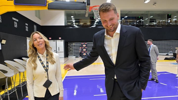 Los Angeles Laker Luka Doncic talks with team co-owner Jeanie Buss following a press conference.