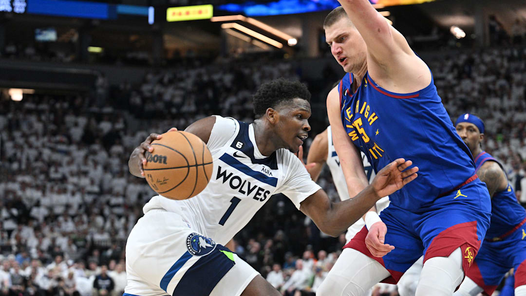 Apr 21, 2023; Minneapolis, Minnesota, USA; Minnesota Timberwolves guard Anthony Edwards (1) goes to the basket as Denver Nuggets center Nikola Jokic (15) defends during the fourth quarter of game three of the 2023 NBA Playoffs at Target Center.