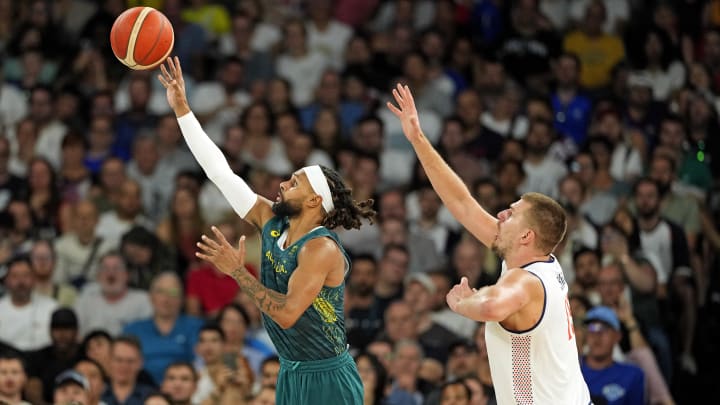 Aug 6, 2024; Paris, France; Australia guard Patty Mills (5) shoots the ball against Serbia power forward Nikola Jokic (15) during the second half in men’s basketball quarterfinals during the Paris 2024 Olympic Summer Games at Accor Arena. Mandatory Credit: Kyle Terada-USA TODAY Sports