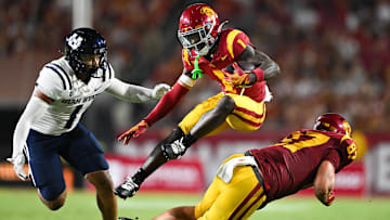 Sep 7, 2024; Los Angeles, California, USA; USC Trojans wide receiver Zachariah Branch (1) runs the ball against Utah State Aggies linebacker Jon Ross Maye (1) during the second quarter at United Airlines Field at Los Angeles Memorial Coliseum. Mandatory Credit: Jonathan Hui-Imagn Images