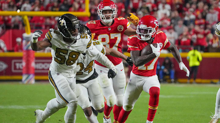 Oct 7, 2024; Kansas City, Missouri, USA; Kansas City Chiefs wide receiver Mecole Hardman (17) runs the ball as New Orleans Saints linebacker Anfernee Orji (58) defends during the second half at GEHA Field at Arrowhead Stadium. Mandatory Credit: Denny Medley-Imagn Images