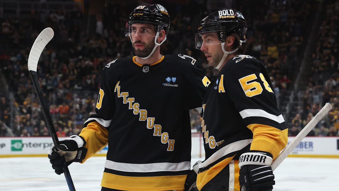 Apr 8, 2025; Pittsburgh, Pennsylvania, USA;  Pittsburgh Penguins defenseman Conor Timmins (20) and defenseman Kris Letang (58) celebrate a goal by Letang against the Chicago Blackhawks during the third period at PPG Paints Arena. Mandatory Credit: Charles LeClaire-Imagn Images