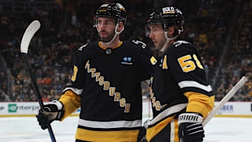 Apr 8, 2025; Pittsburgh, Pennsylvania, USA;  Pittsburgh Penguins defenseman Conor Timmins (20) and defenseman Kris Letang (58) celebrate a goal by Letang against the Chicago Blackhawks during the third period at PPG Paints Arena. Mandatory Credit: Charles LeClaire-Imagn Images
