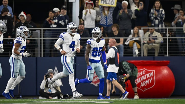 Dec 24, 2022; Arlington, Texas, USA; Dallas Cowboys quarterback Dak Prescott (4) and wide receiver CeeDee Lamb (88) celebrates after Prescott throws a touchdown  pass tp Lamb against the Philadelphia Eagles during the second quarter at AT&T Stadium. 