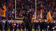 Nov 13, 2021; Charlottesville, Virginia, USA; The Virginia Cavaliers mascot CavMan, aboard his horse Sabre, lead cheerleaders and Cavaliers players onto the field prior to their game against the Notre Dame Fighting Irish at Scott Stadium.  