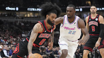 Apr 9, 2025; Chicago, Illinois, USA; Miami Heat forward Andrew Wiggins (22) defends Chicago Bulls guard Coby White (0) during the first quarter at United Center. Mandatory Credit: David Banks-Imagn Images